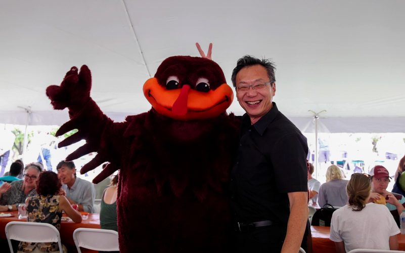 Dean Liu with the HokieBird outside at picnic
