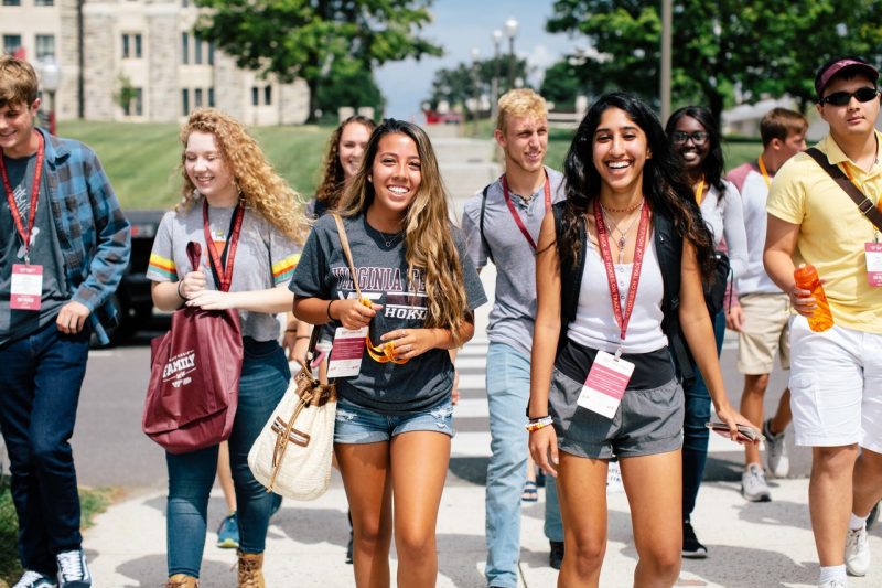 Excited students walk through campus.