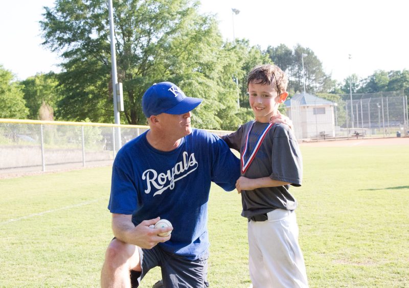 Matt Powers as a a little league baseball coach outside.