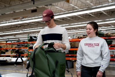 Two students working together on care backpack
