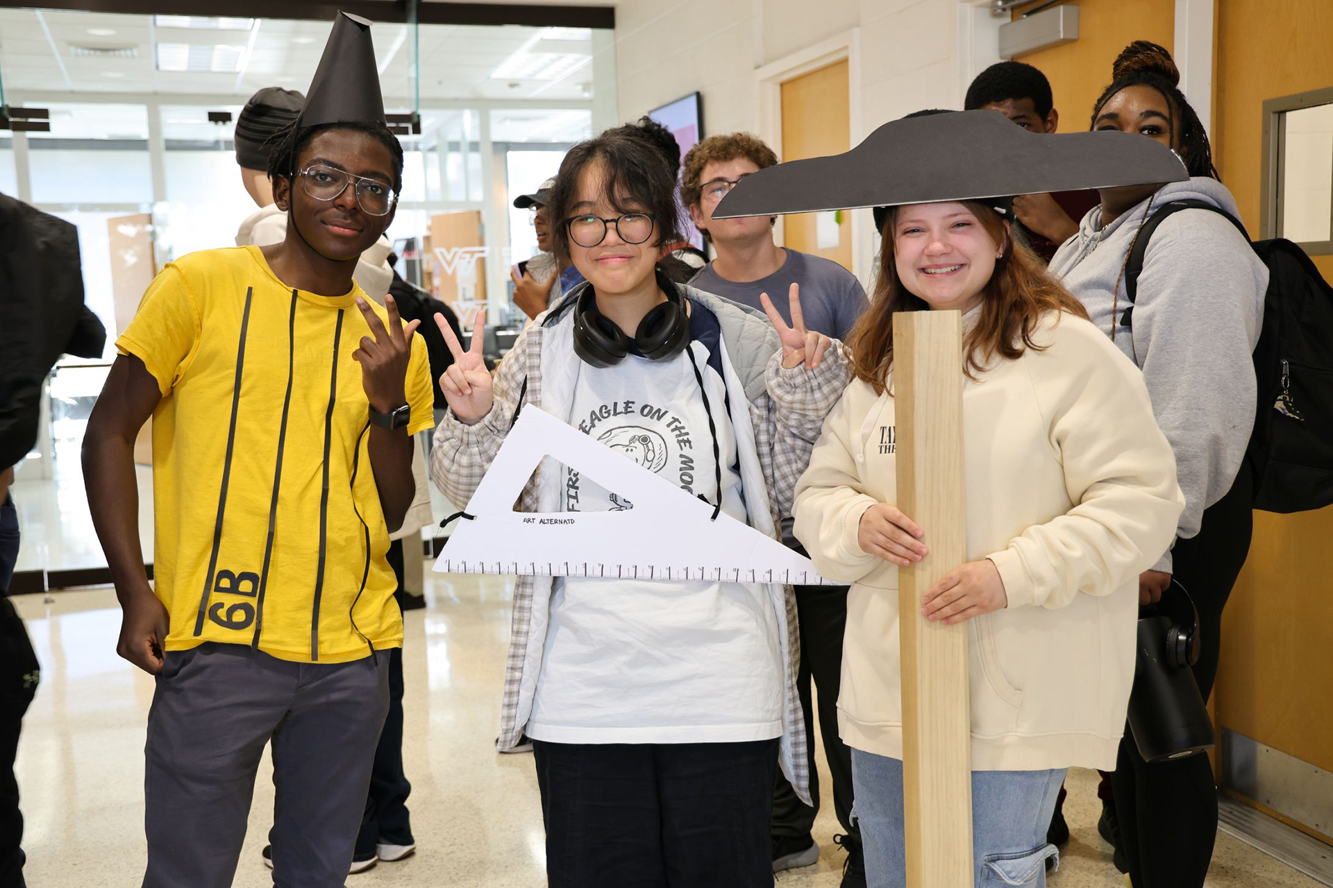 Three students dressed up in architecture themed Halloween costumes.
