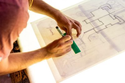 Close up of hands sketching on a light box.