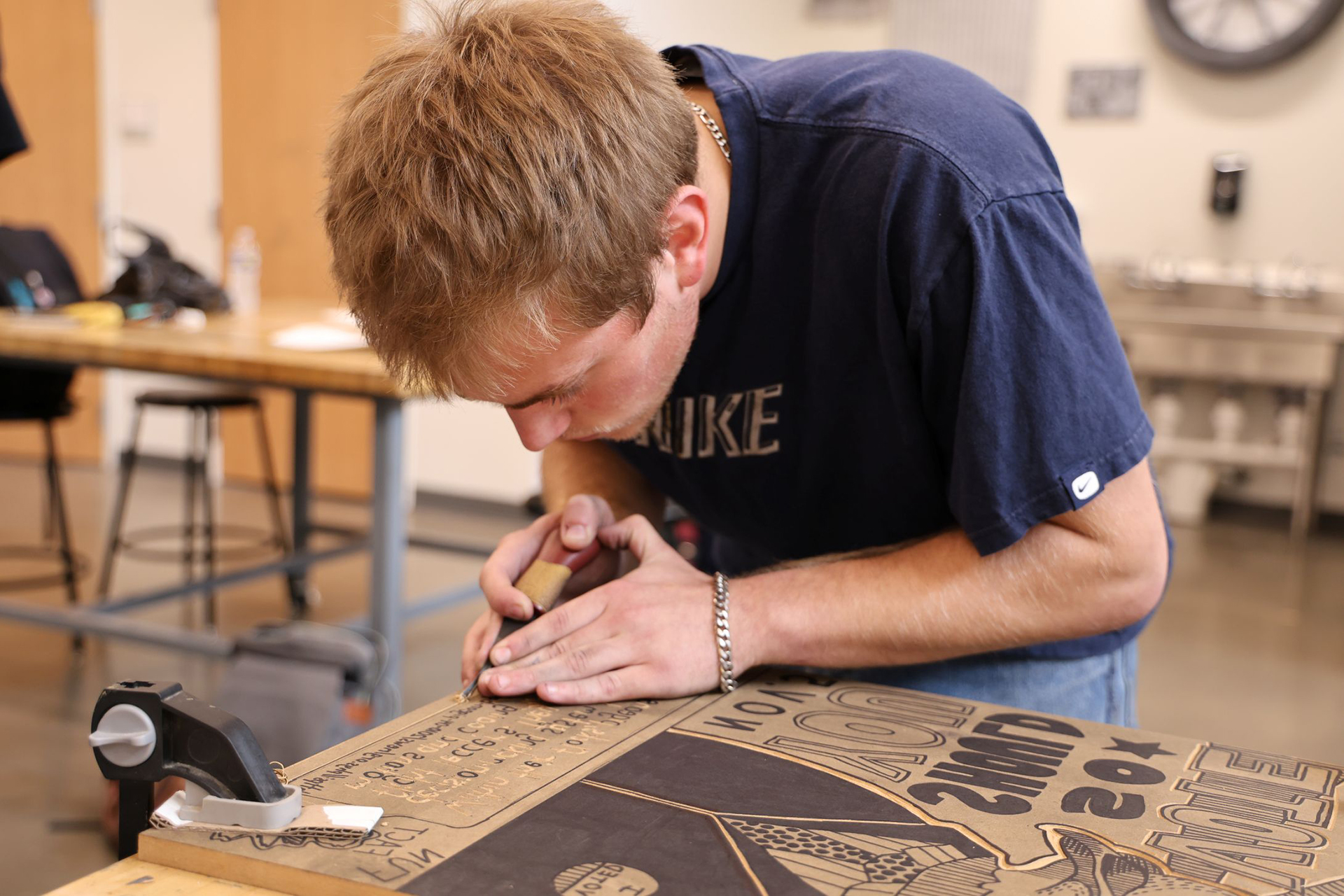 Student carving block for screenprinting.