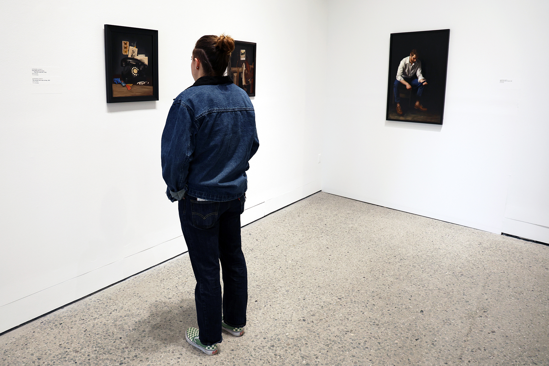 Student looking at art in a gallery.