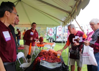 Dean Liu in conversation with guests at tailgate.