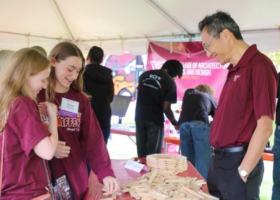 Dean Liu in conversation with guests at tailgate.