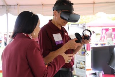 Dean Liu wearing VR headset interacting with researcher.