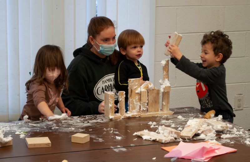 three children assembling a wooden-block castle at Little Hokie Hangout